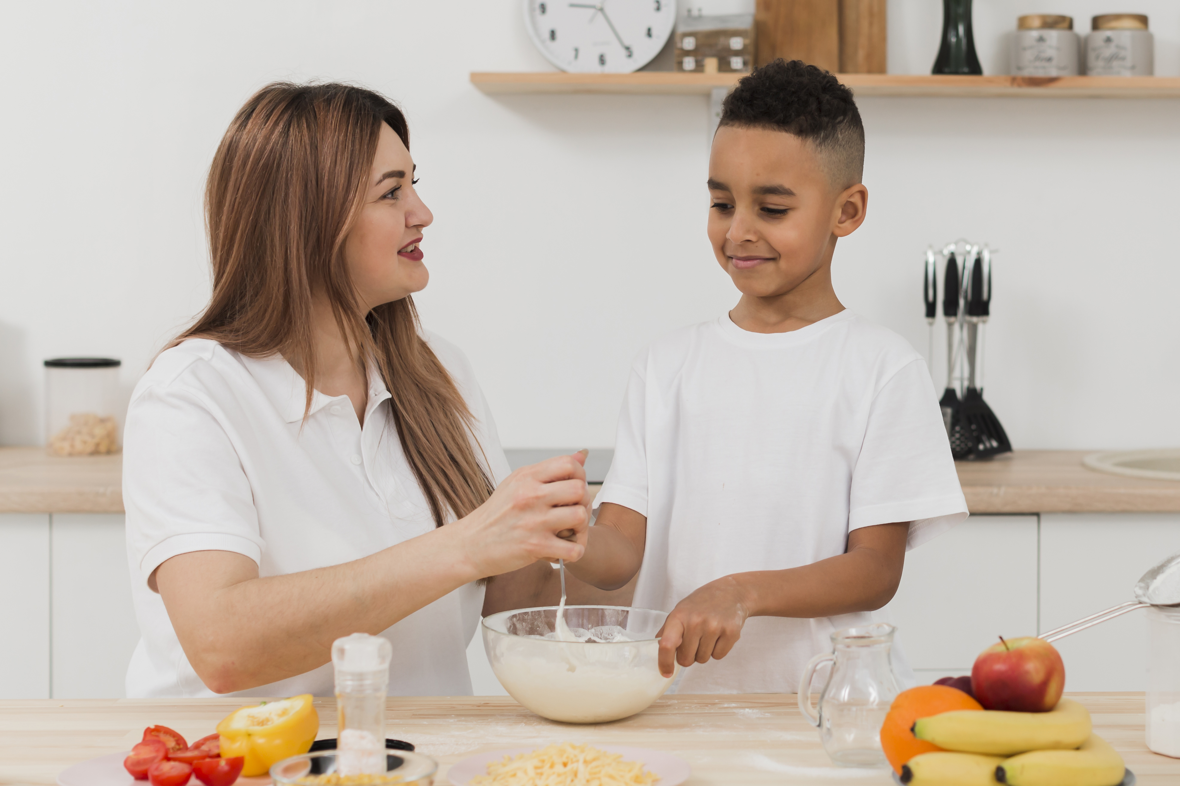 mother-teaching-son-prepare-food-kitchen